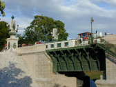 The bridge is of iron construction on masonry piers.