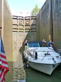 A motorboat completing the exciting passage through the 11-meter lock #34b, at Crissey.